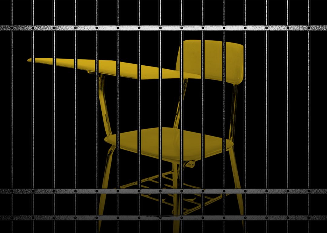 A school chair behind bars.