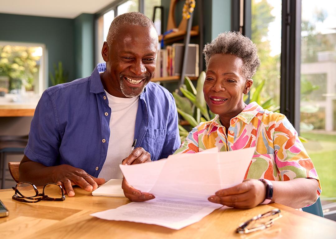Senior couple at home reviewing finances.