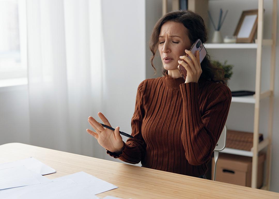 Woman worryingly talking on the phone.