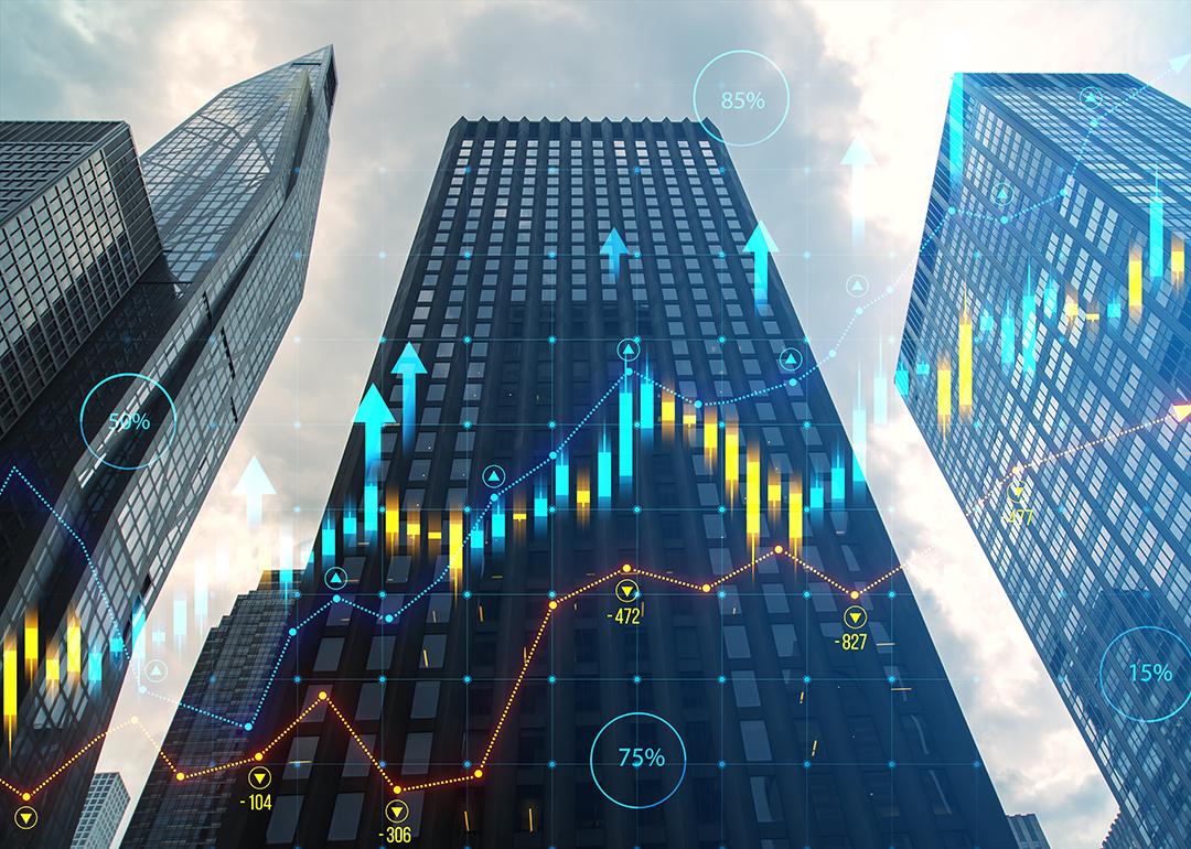 Skyscrapers illustrated with financial charts overlay.