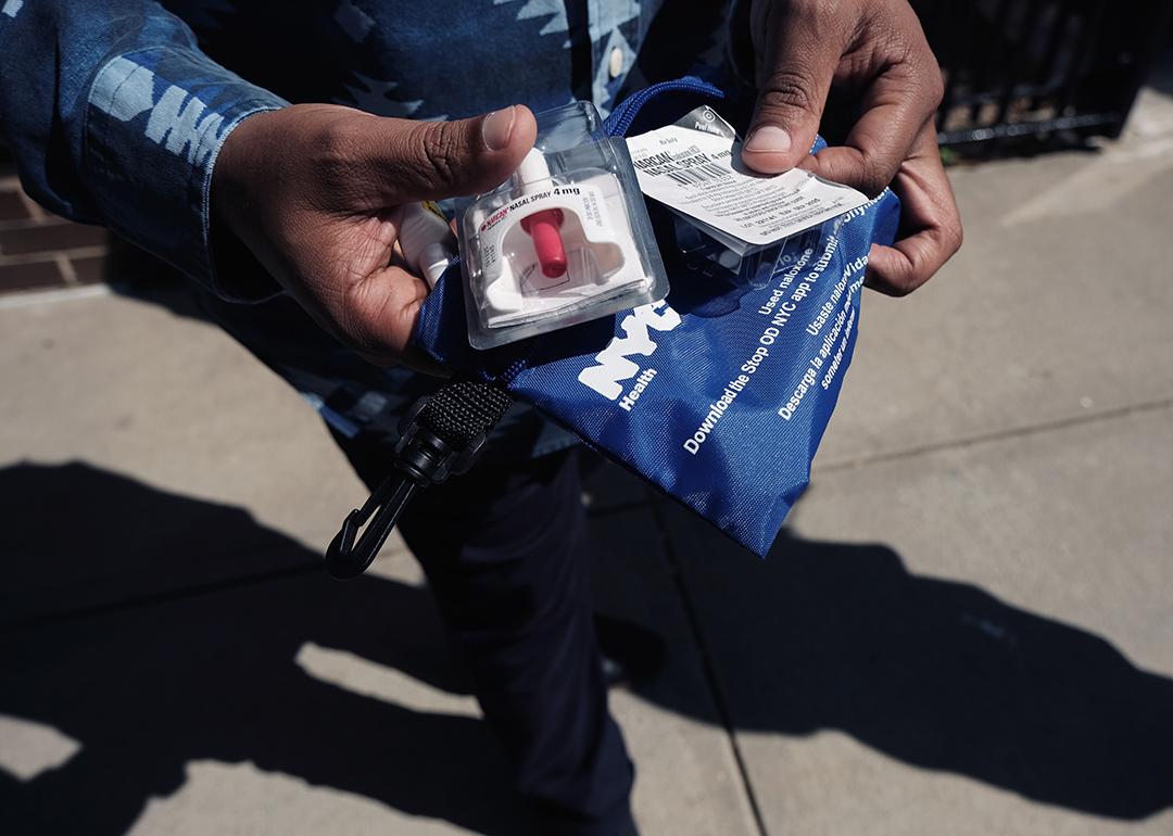 A Services for the UnderServed (S:US) worker holds a naloxone overdose kit.