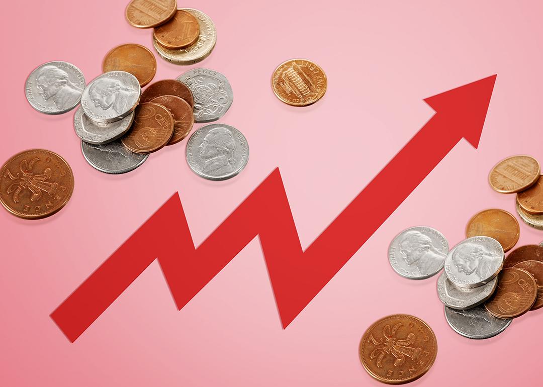 Rising arrow to depict rising costs against a background of coins.