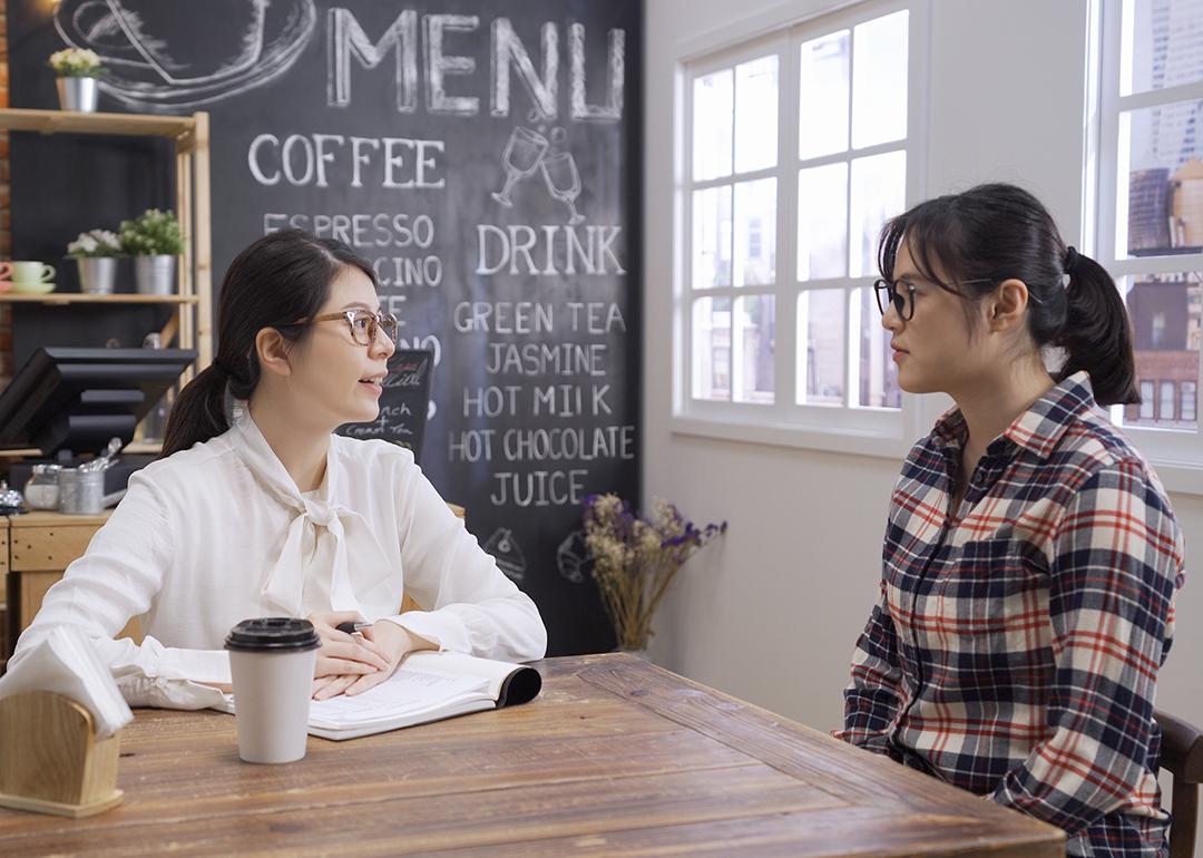Cafe business owner interviewing a candidate for the business marketing staff.