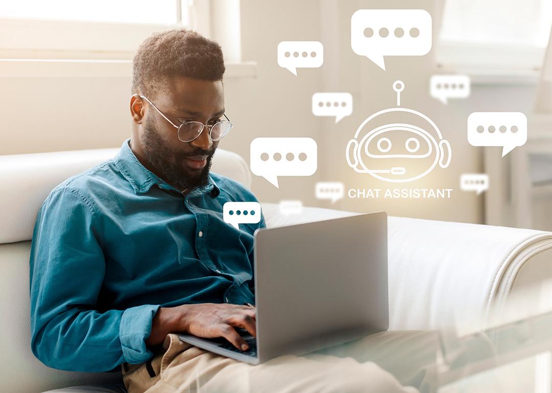 Man sitting on the couch at home using a laptop to chat with an AI bot.