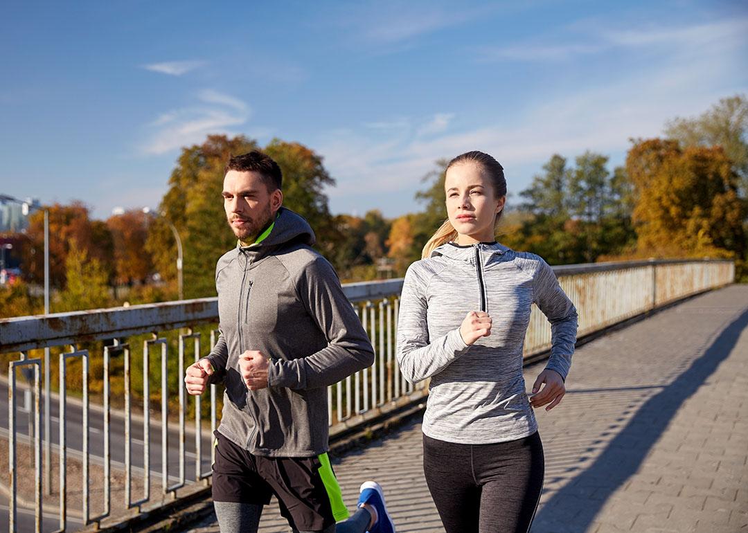A couple running outdoors in the morning.