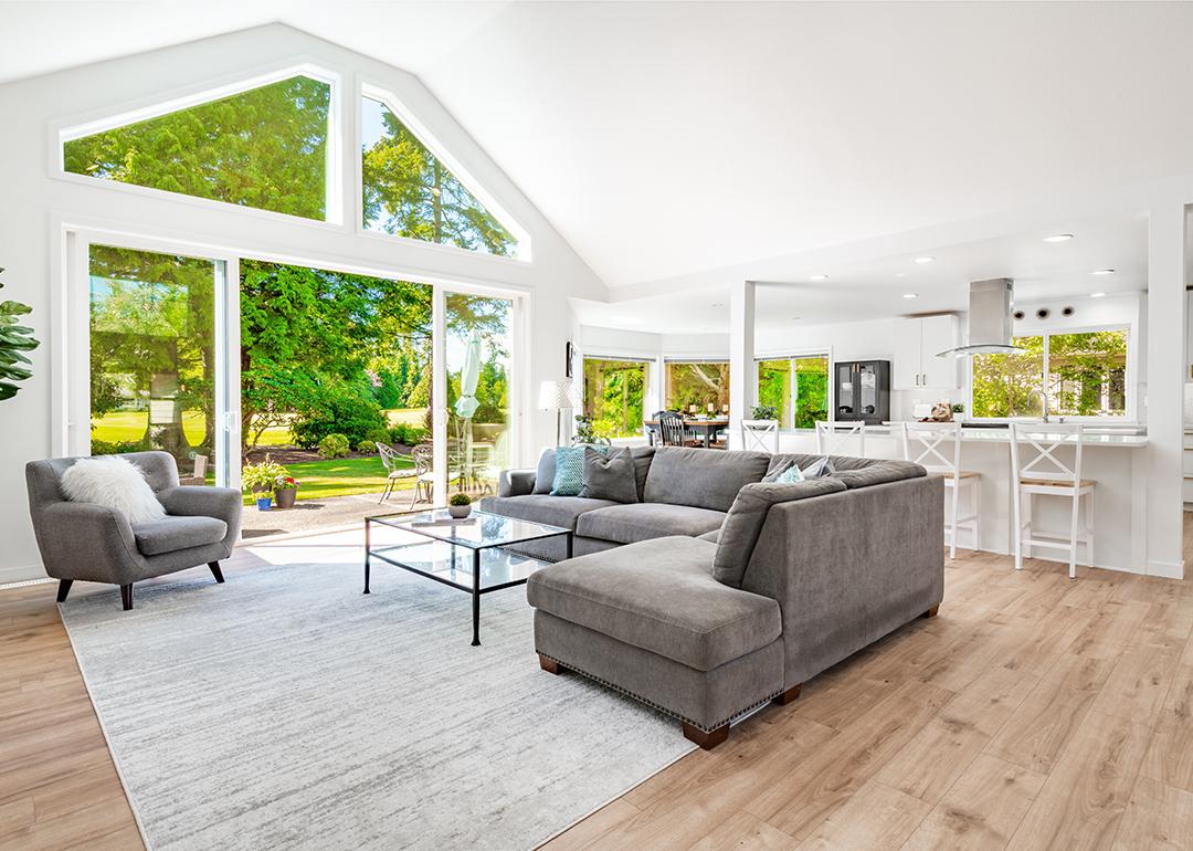A large open living room with multiple expansive windows.