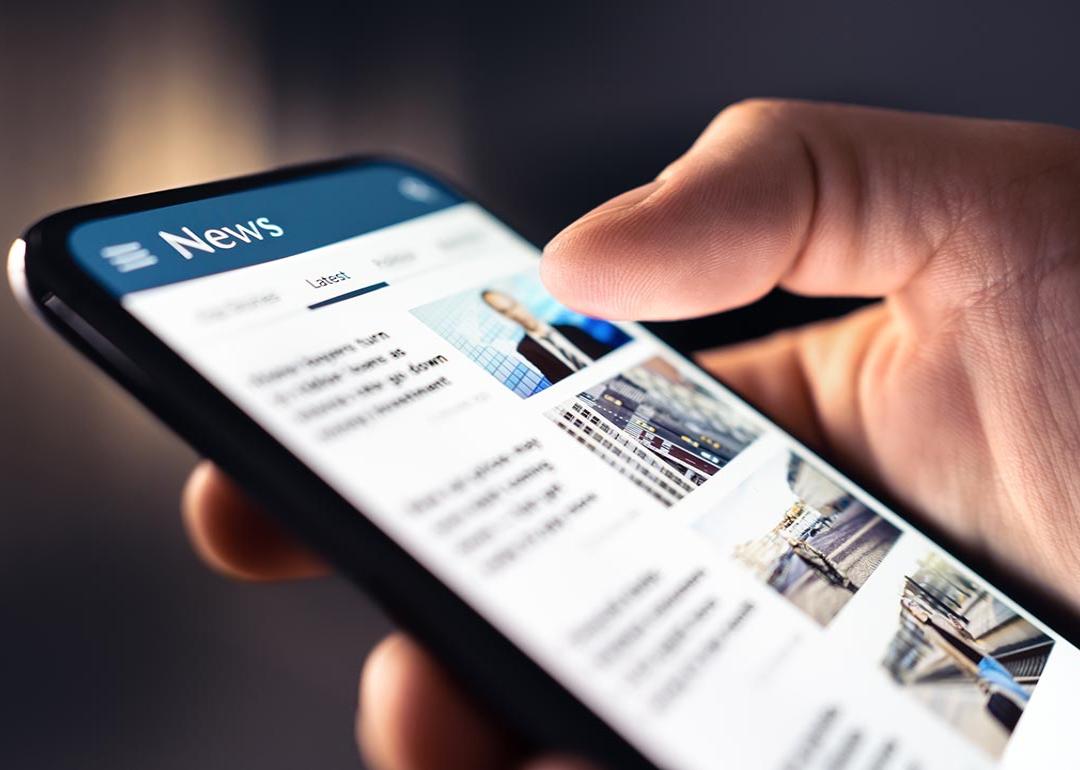Person using phone to browse news.