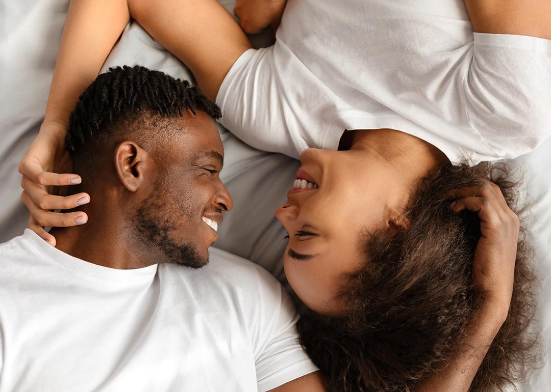 A black couple enjoying intimacy in bed.