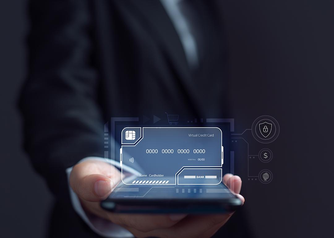 Businessman using an electronic credit card illustrated as a virtual screen.
