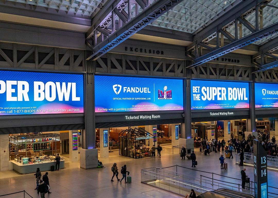 Ads for FanDuel, an online sports gambling copany, displayed on huge screens in the Moynihan Train Hall of Pennsylvania Station prior to the Super Bowl.