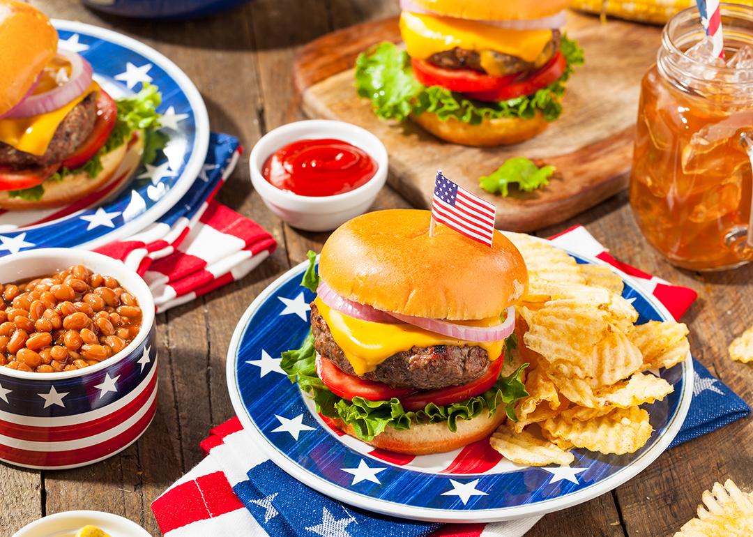 A set of homemade Fourth of July picnic meal such as burger, fries, and beans.