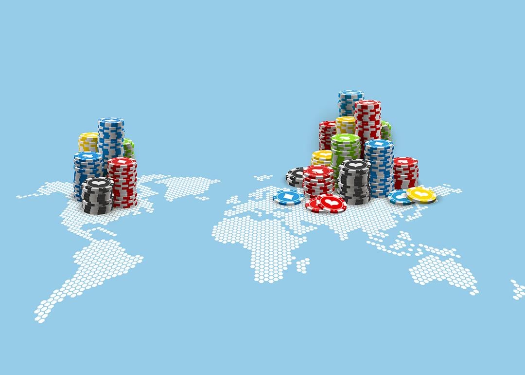 Colored casino chips on an illustration of the world map.