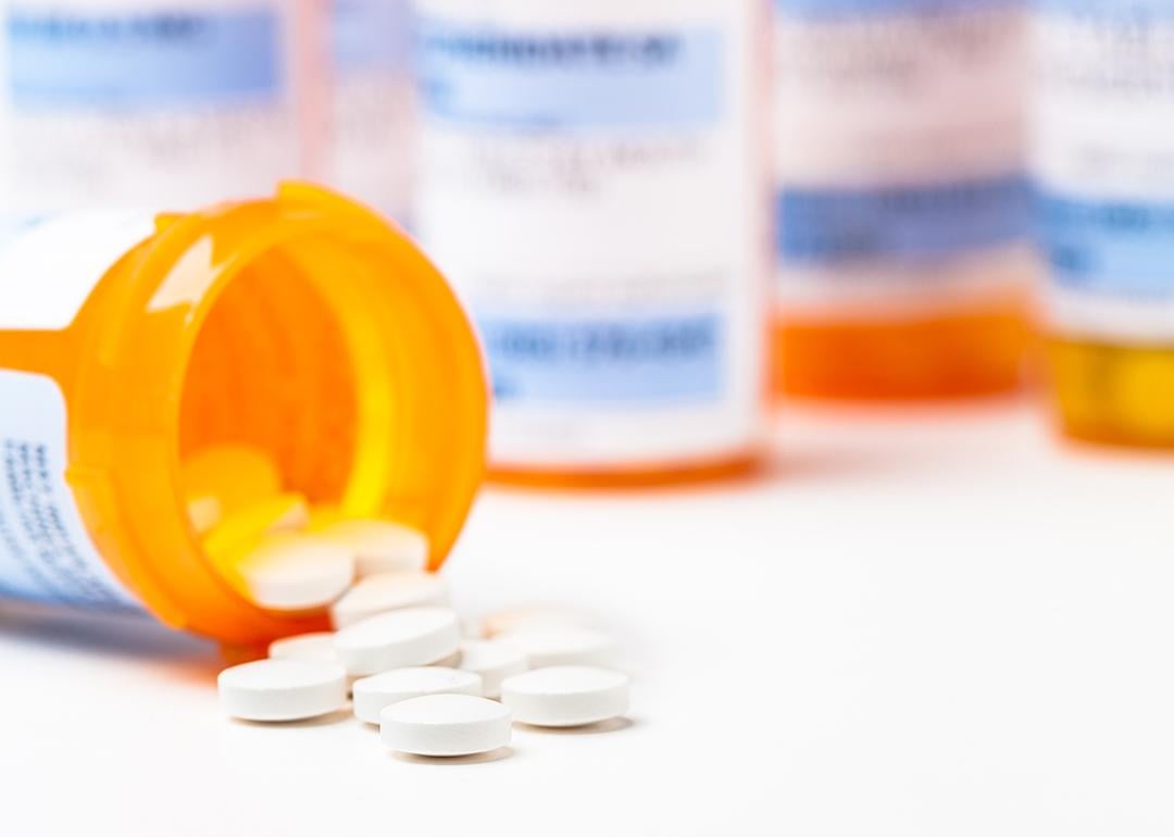 Prescription tablets spilling from bottle.