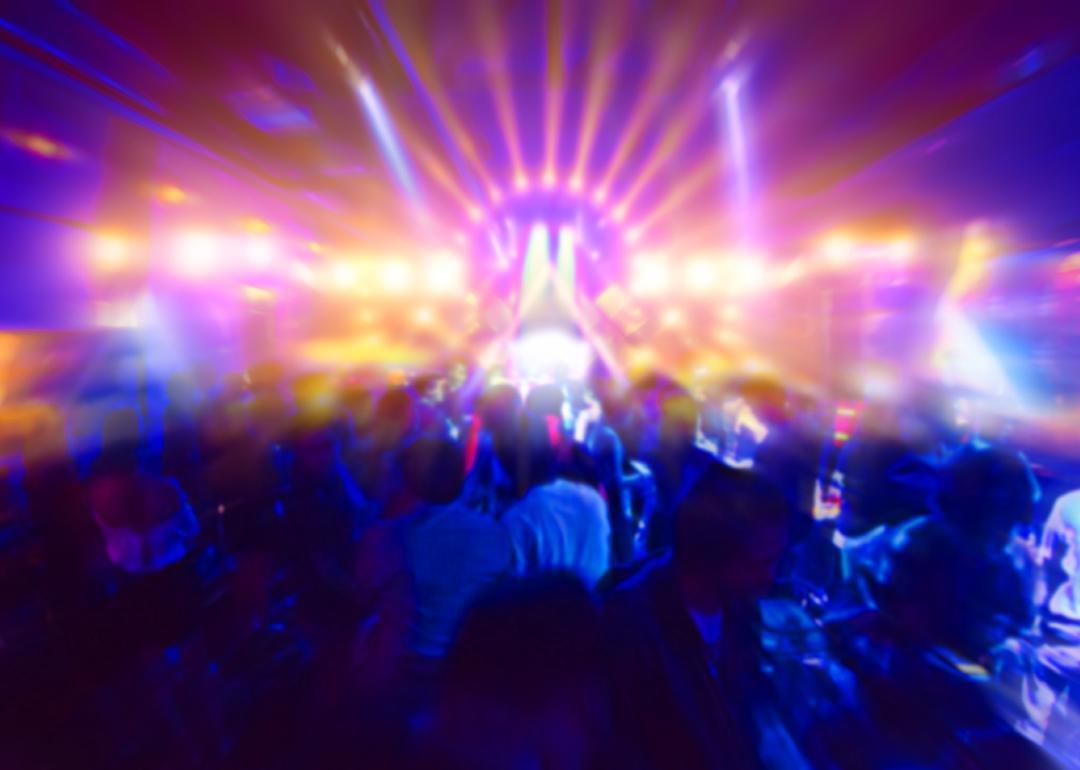 Concert crowd in front of bright stage lights.