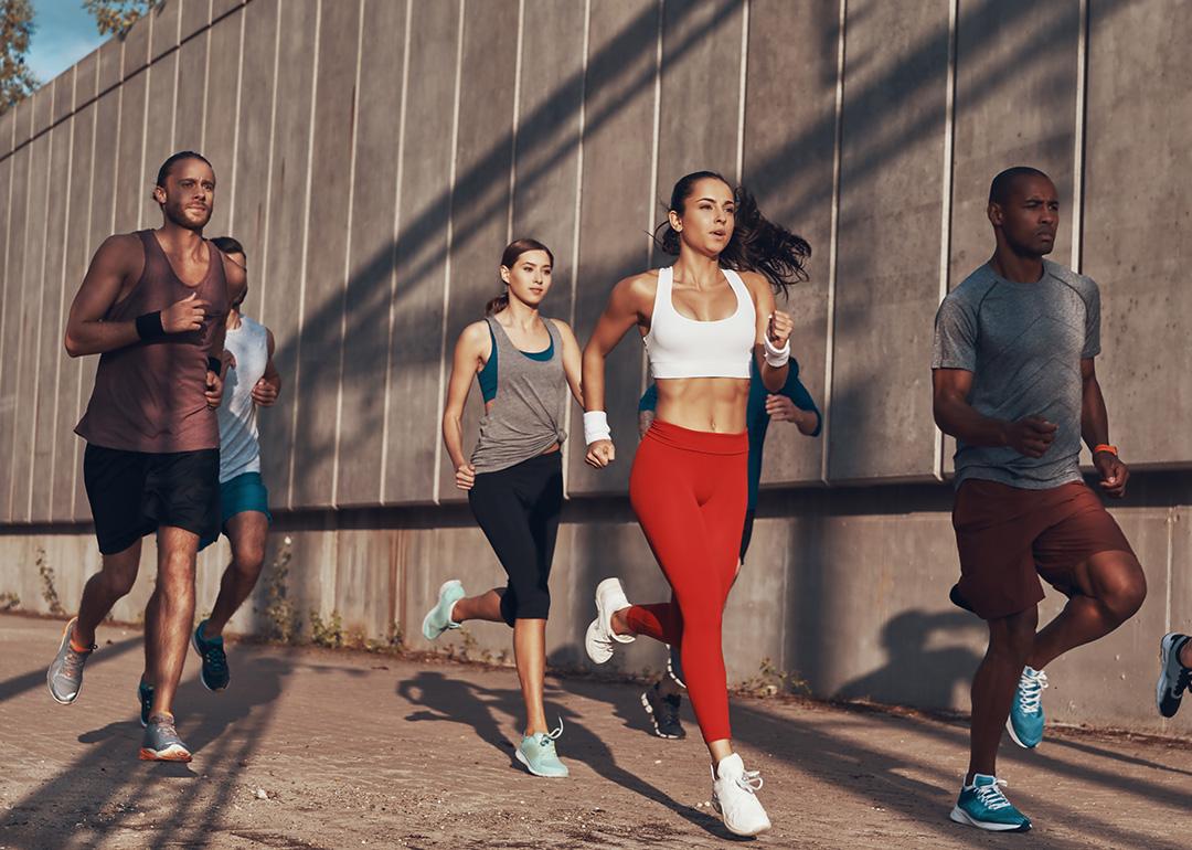 A group of people jogging outdoors.