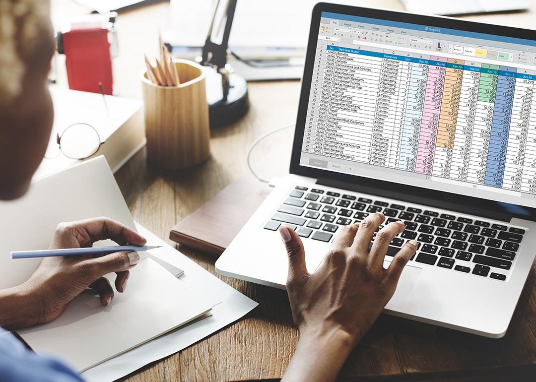 Young female entrepreneur looking at a spreadsheet report.