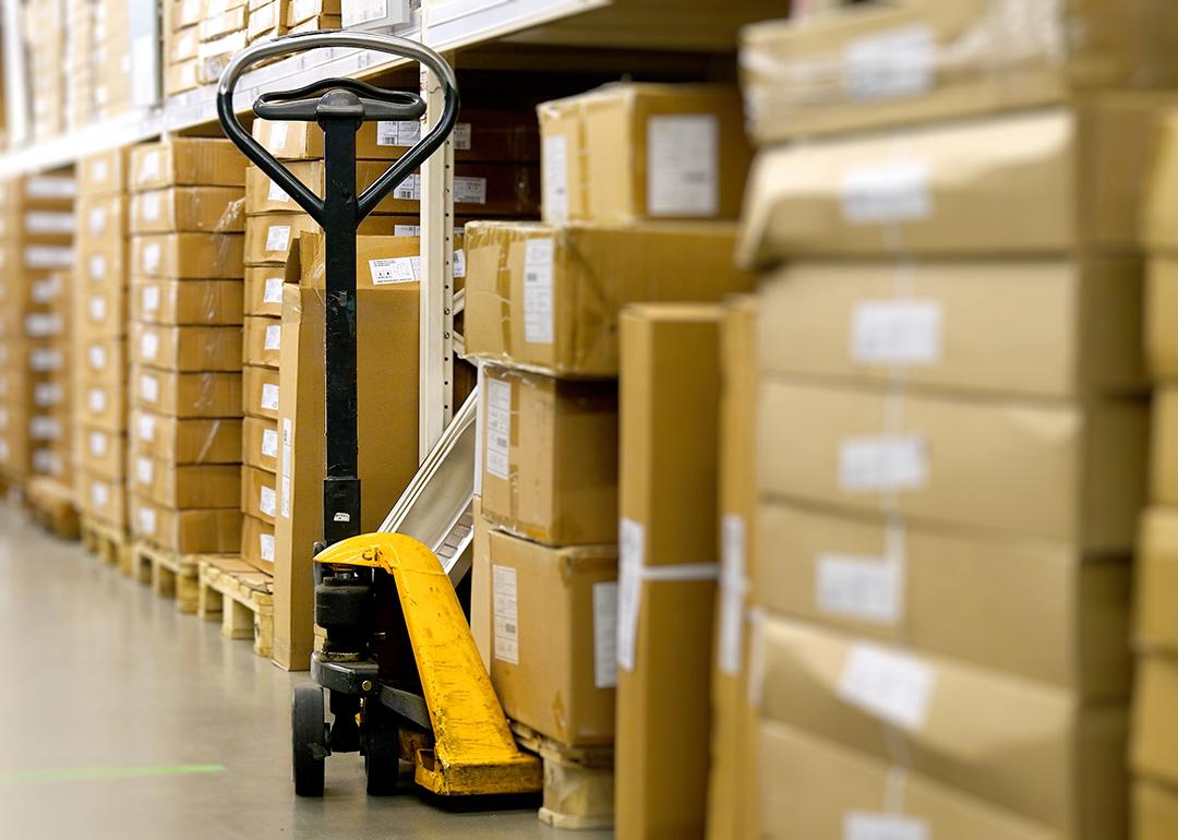 A manual pallet jack in a warehouse aisle.