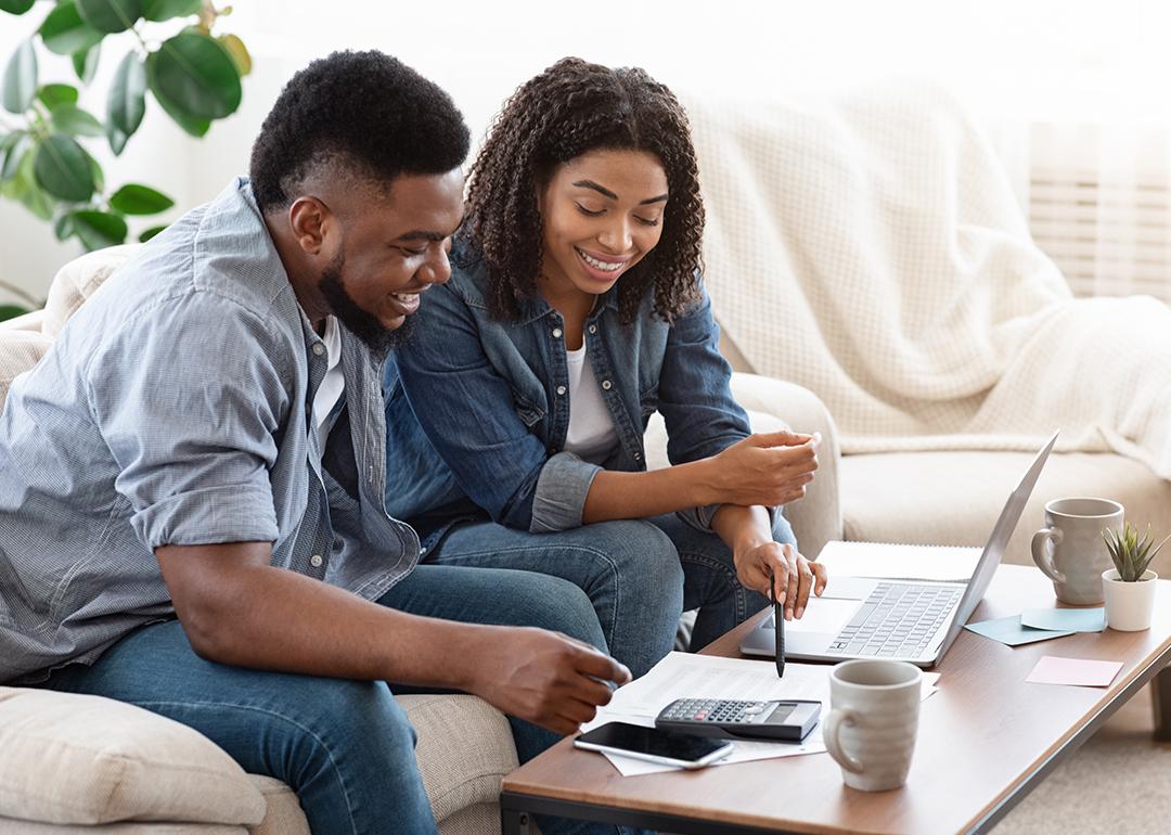 A black couple engaged in a discussion about finances.