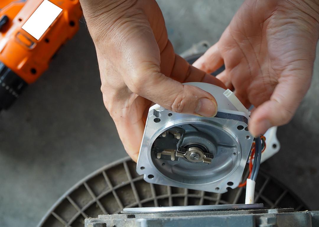 A mechanic repairing an AC servo motor.