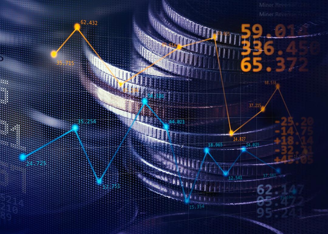 Stack of coins illustrated with stock exchange graphics.