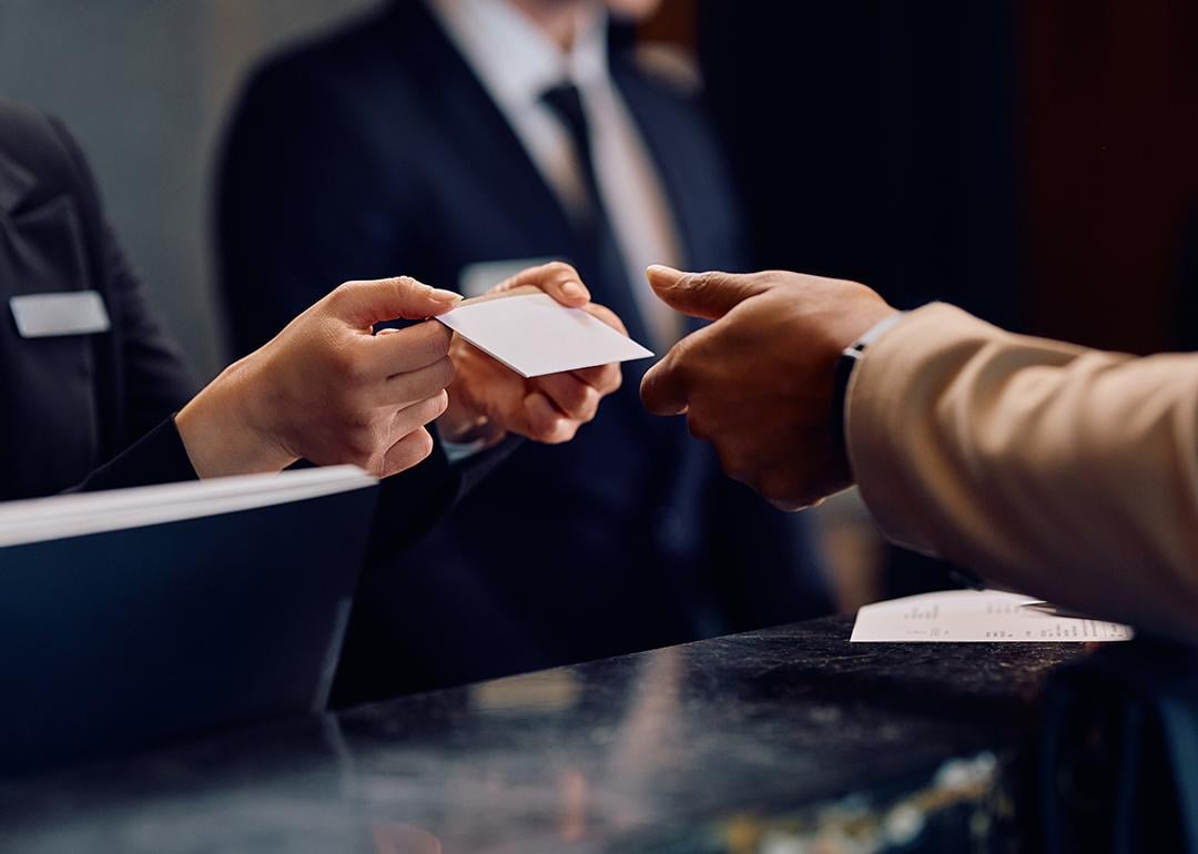Hotel guest receiving a card key at the hotel reception.