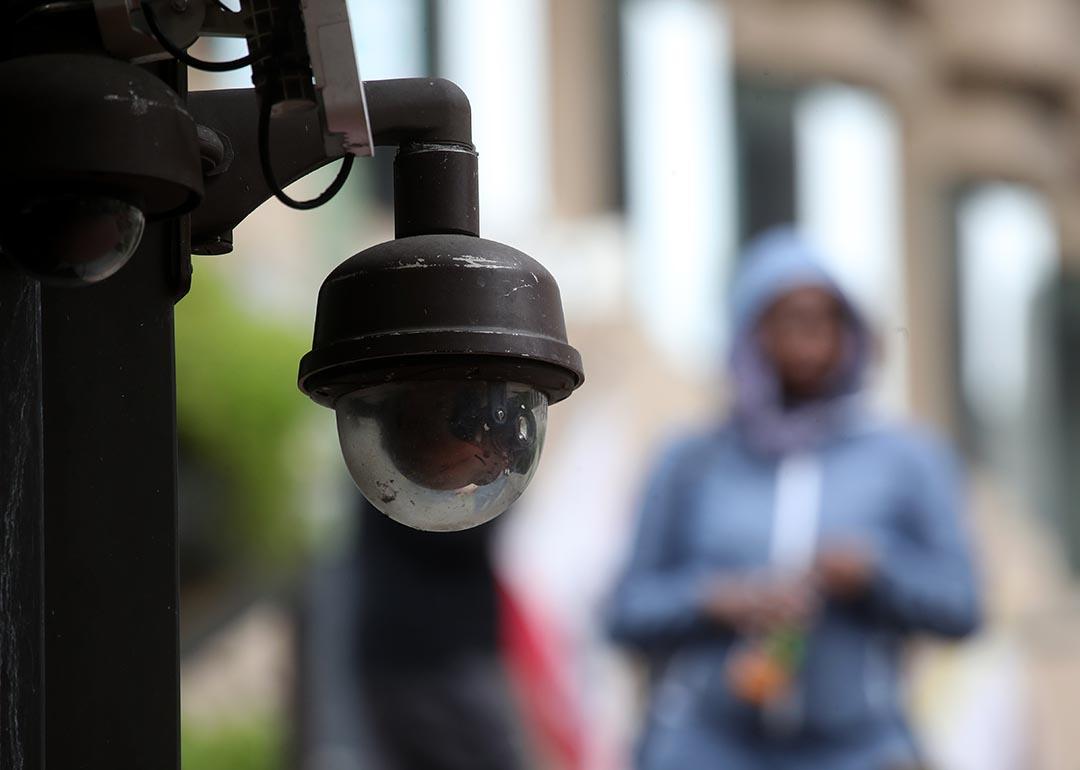 Close up of a video surveillance camera hanging from the side of a building in San Francisco.