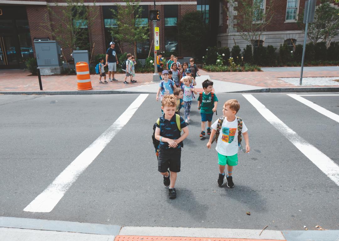 Kindergarten children group walking on crosswalk at Charles Street in Boston.