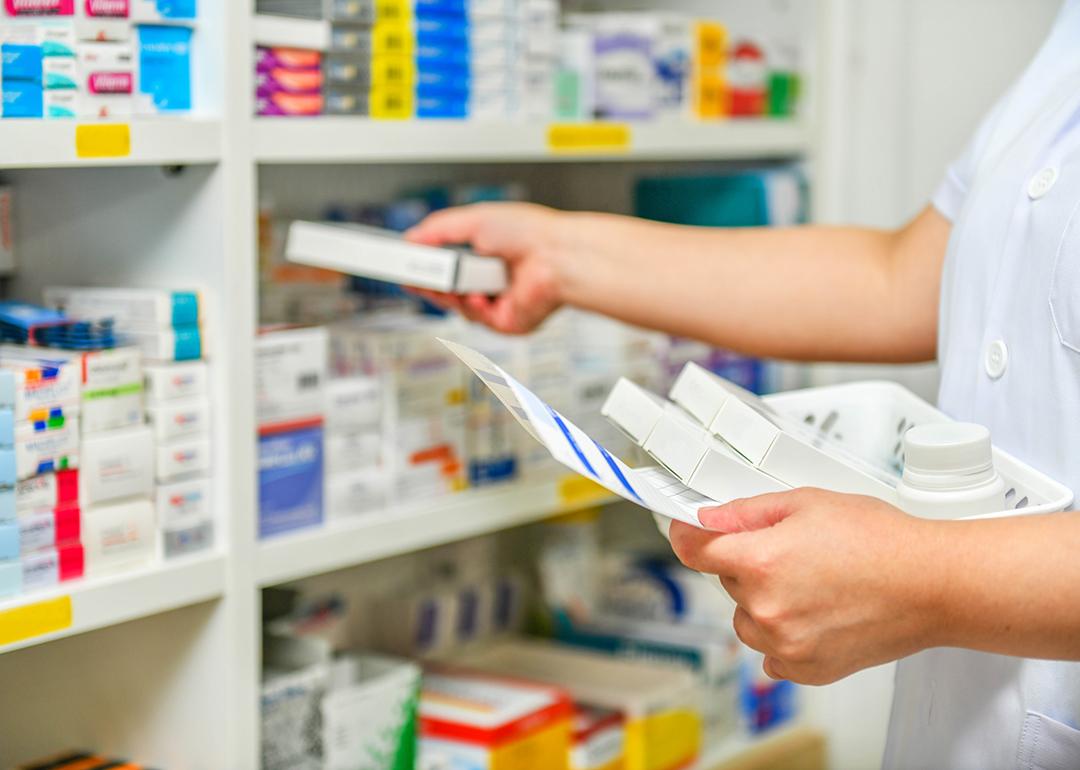 A pharmacist filling prescription at a pharmacy.