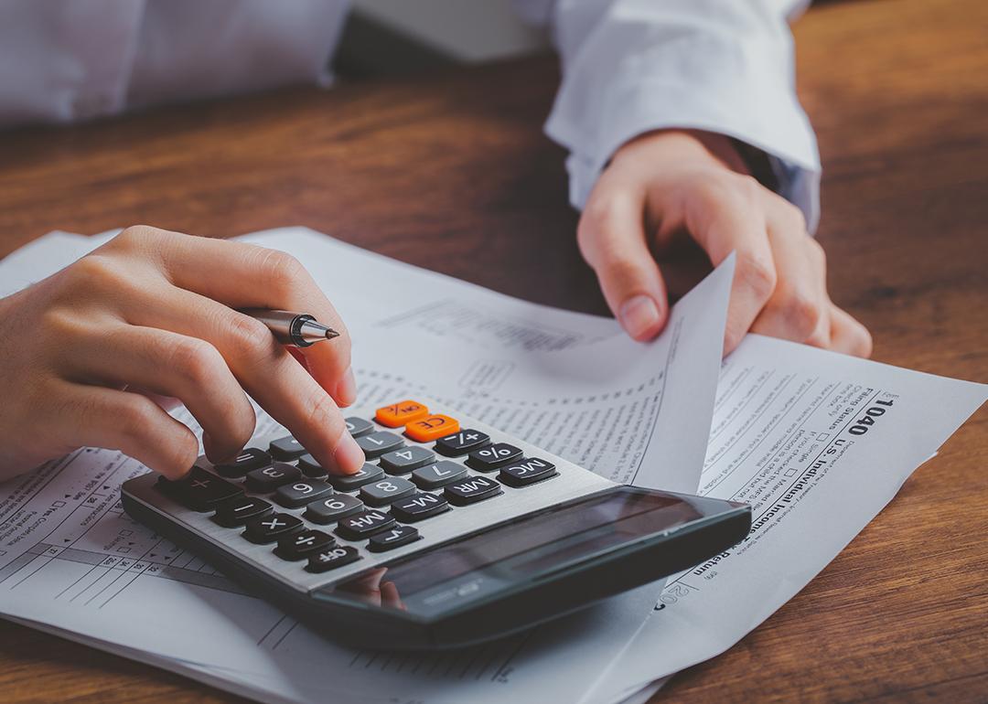 Business person calculating taxes.