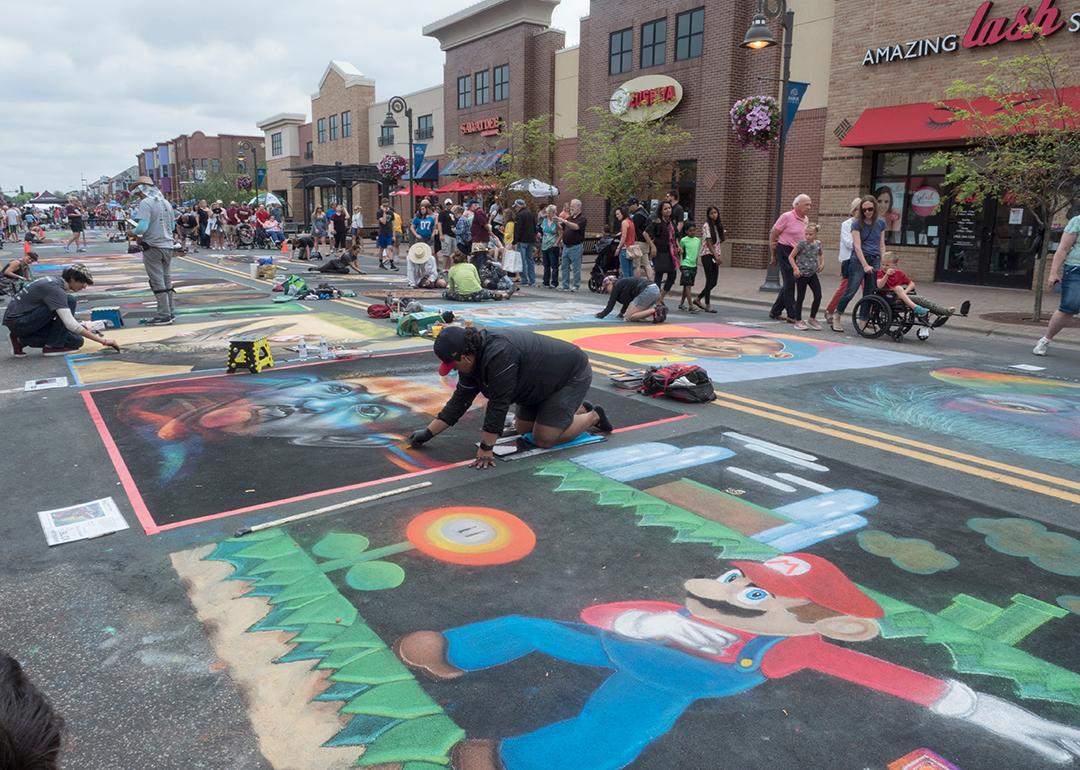 Chalk artists creating art during the Chalk Art Festival in Maple Grove, Minnesota.