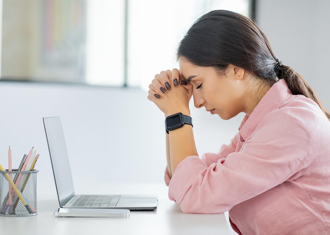 Young professional having a headache at work.