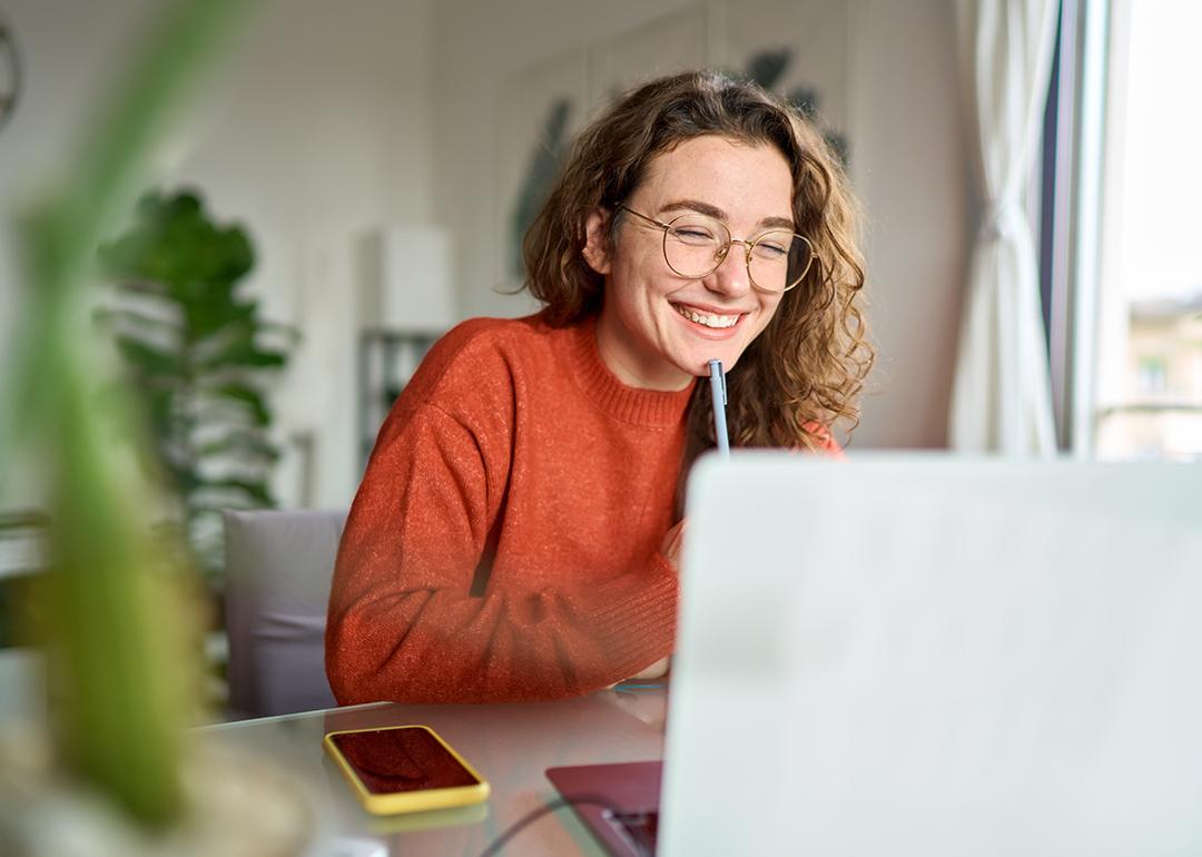 Young Gen Z professional at home watching a webinar.