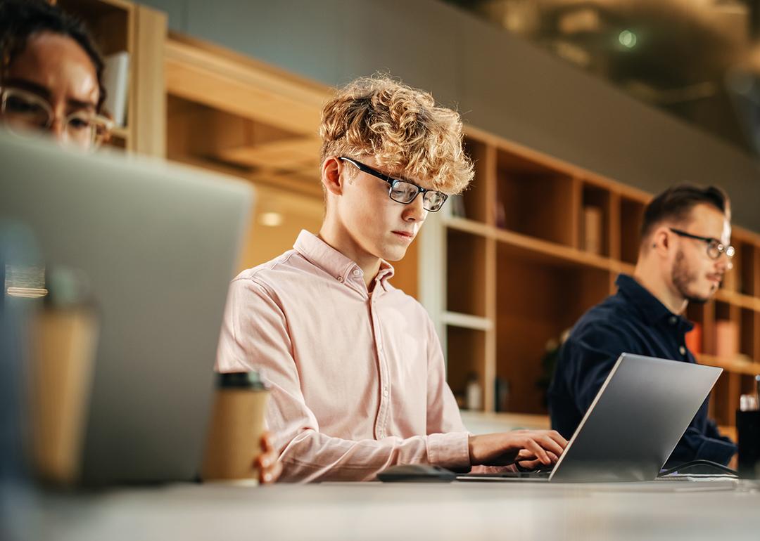 A group of software engineers working using their laptops.