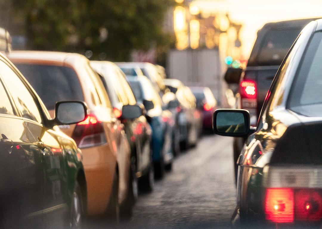 A lane of cars on the road during rush hour.