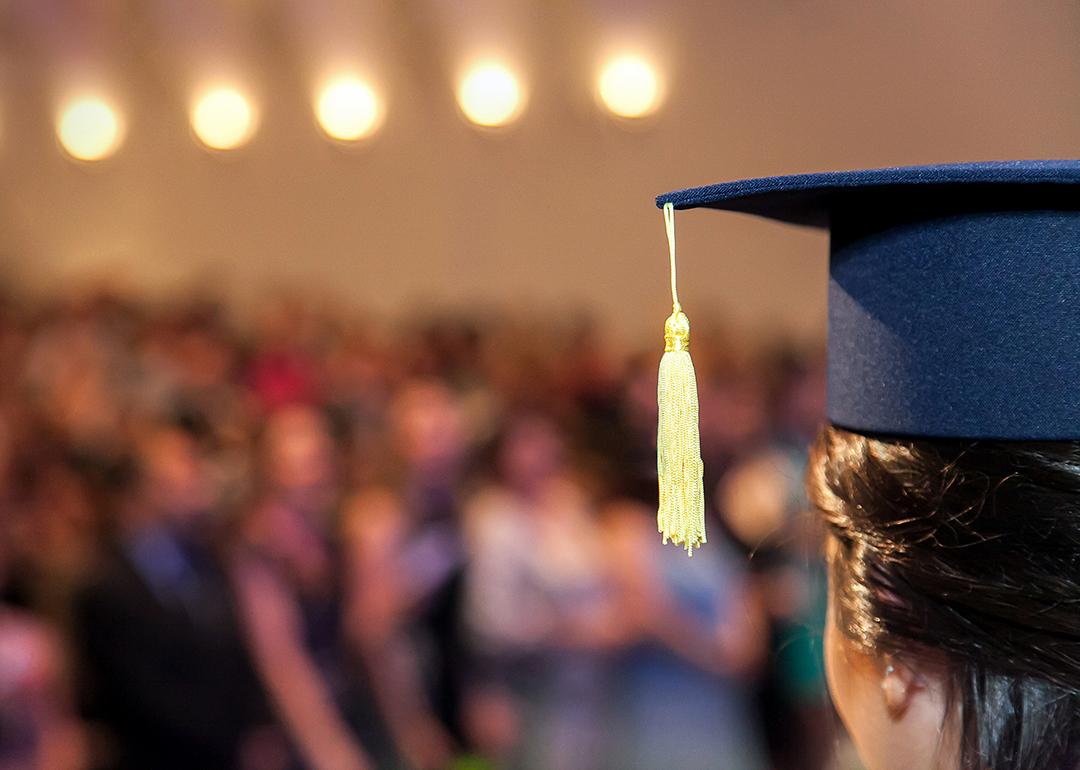 A graduating student facing the ceremony crowd.
