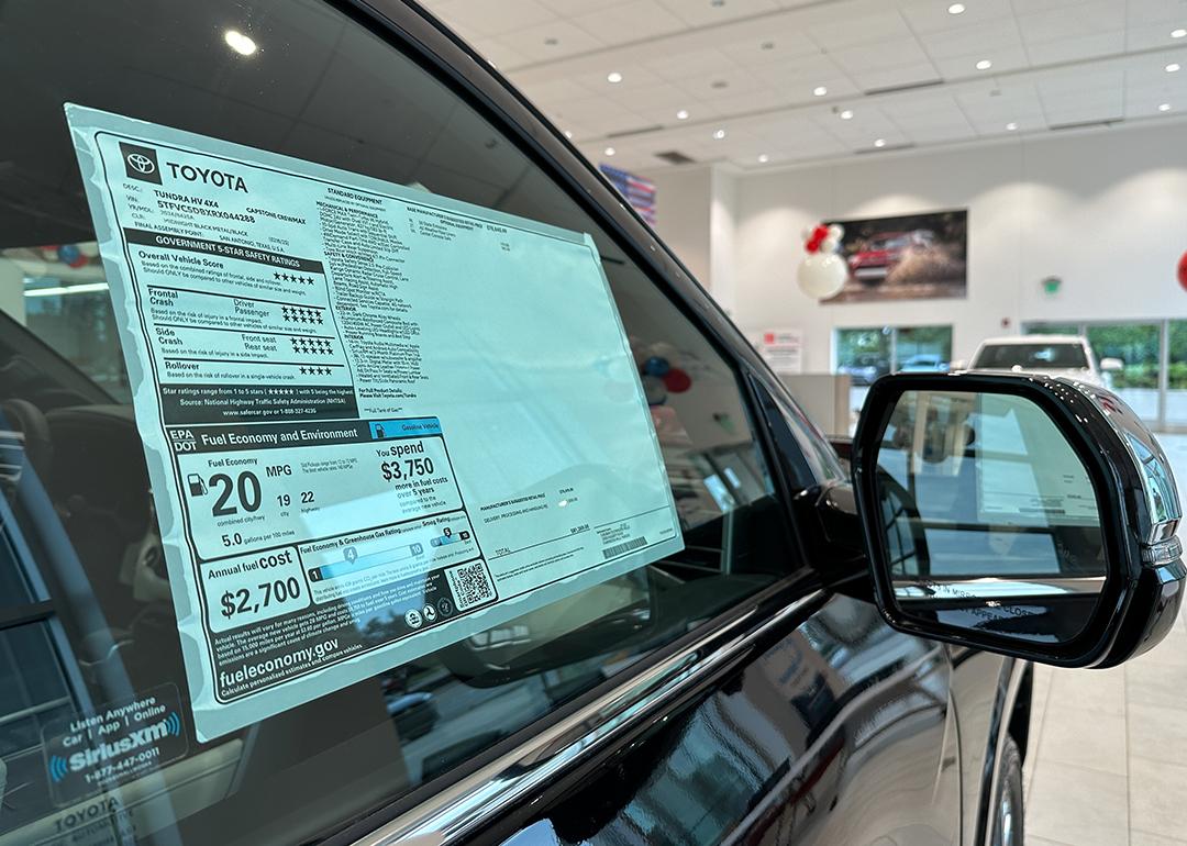 A car dealer's pricing sticker on a Toyota Tundra vehicle.