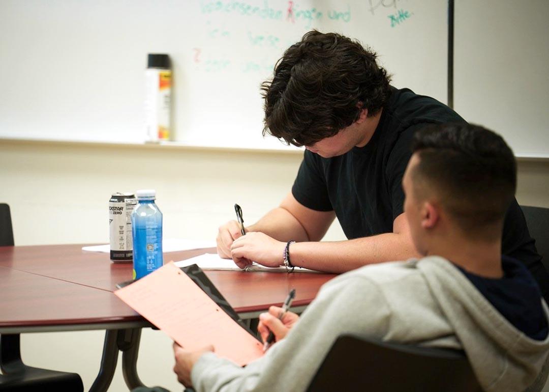 Students take notes during Dr. Adam Kaiserman's English class at College of the Canyons in Santa Clarita.