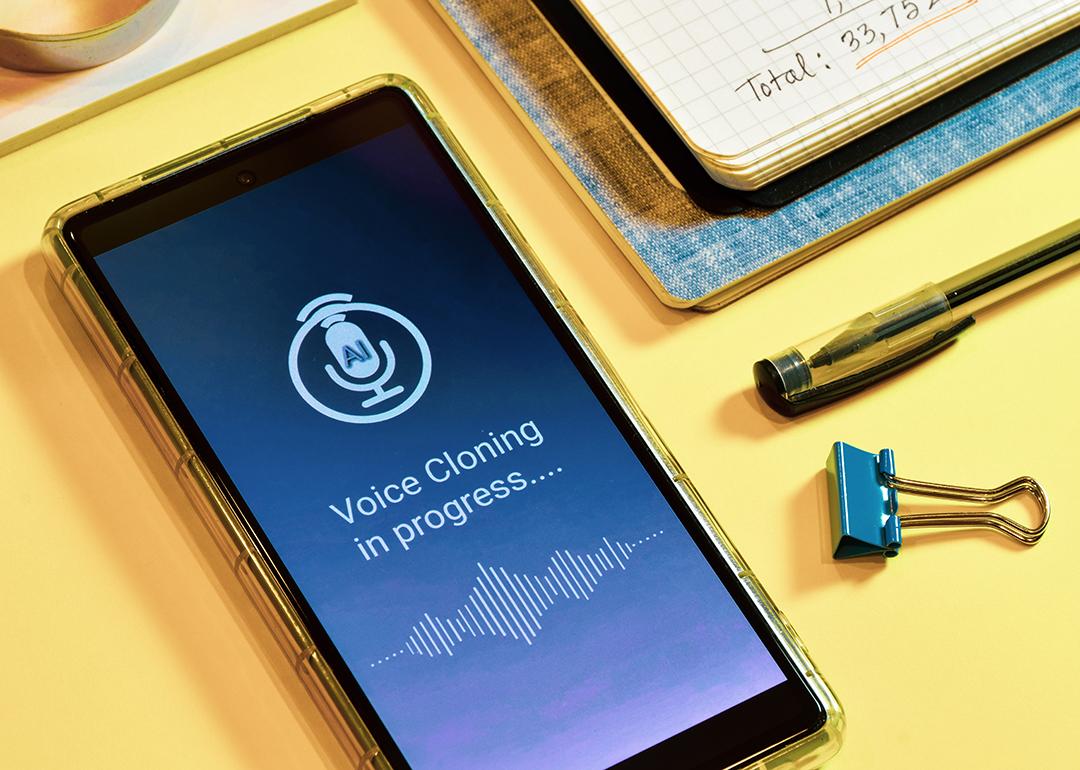 'Voice cloning in progress' displayed on a smartphone.