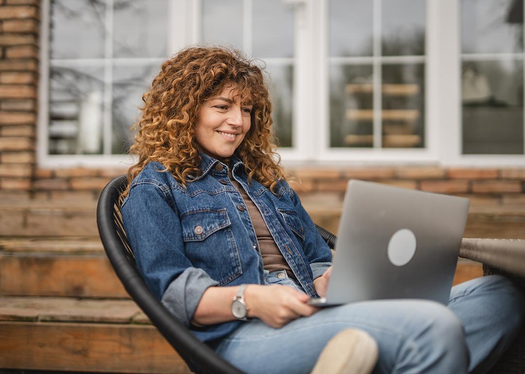 Woman sitting at home while browsing information using a laptop.
