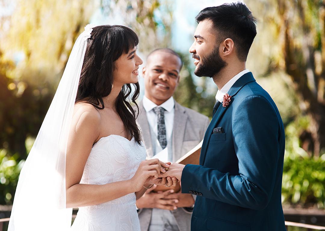 Happy couple exchanging vows during their wedding ceremony.