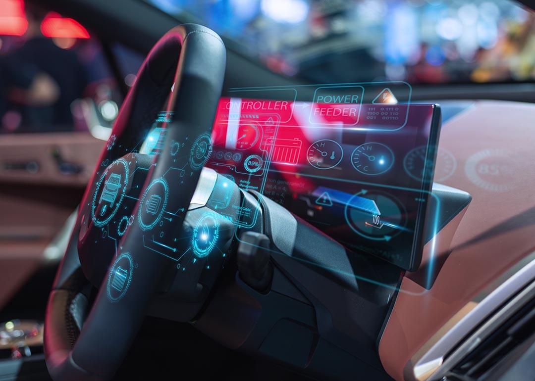 Close-up of a futuristic car dashboard featuring a digital interface with holographic displays and advanced controls.