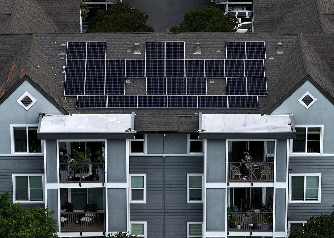 Aerial view of solar panels are on the roof of an apartment complex in California.