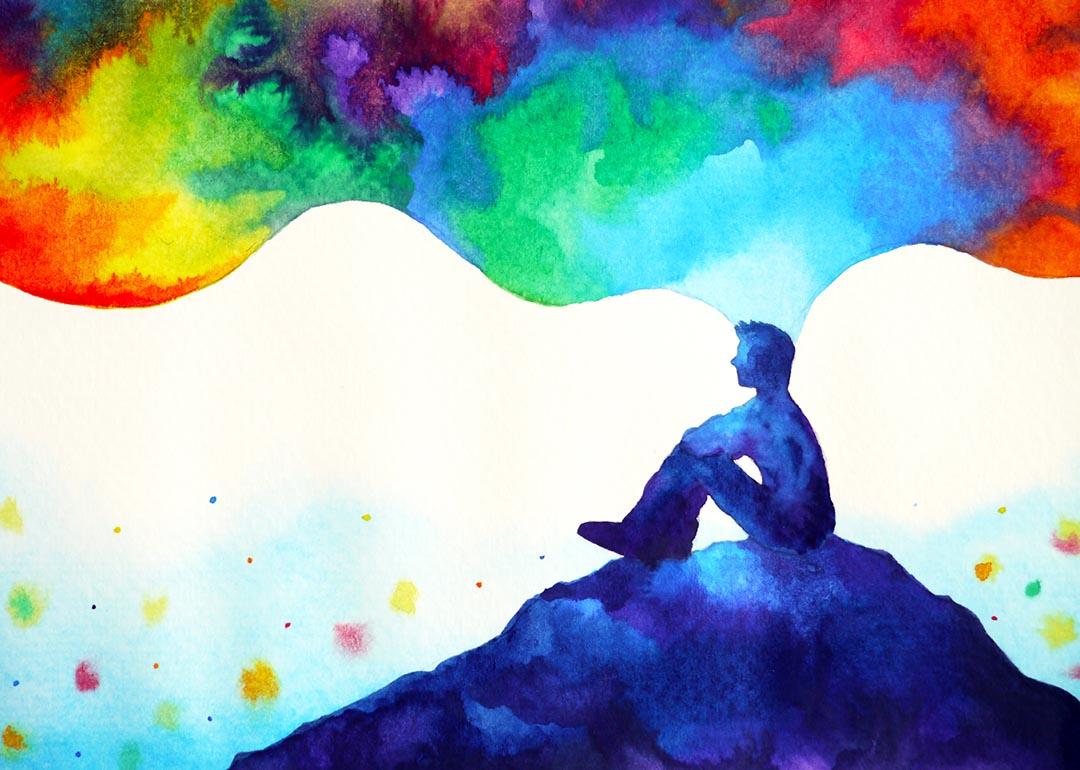 Abstract art watercolor painting illustration of person sitting on a hill with thoughts depicted in rainbow clouds floating above.