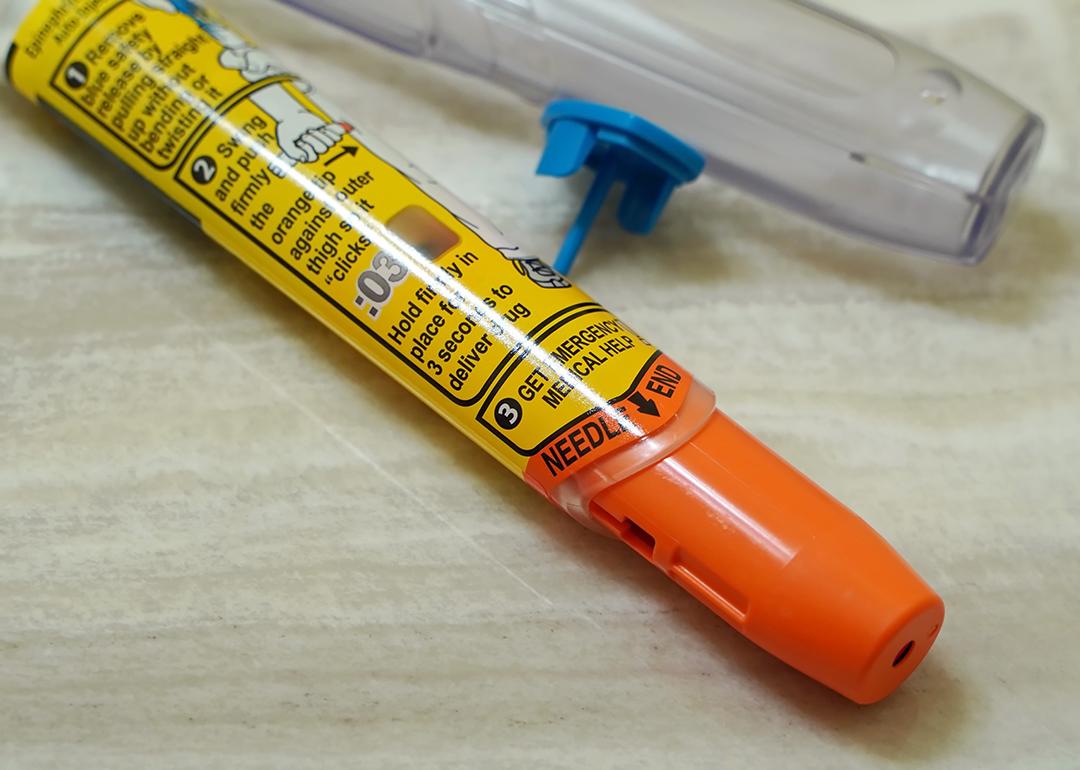 A discarded Epipen auto injector lying beside a sink.