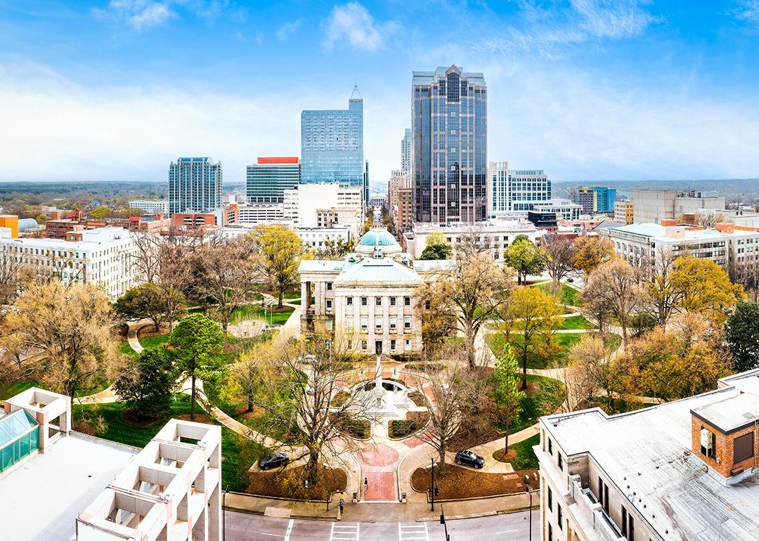 Aerial view of the North Carolina State Capitol and Raleigh skyline.