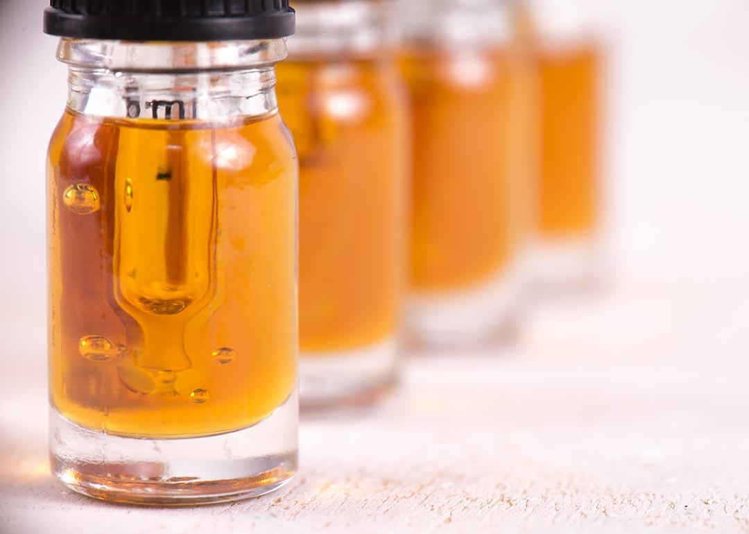 Macro detail of dropper with CBD oil, cannabis live resin extraction isolated on white background.
