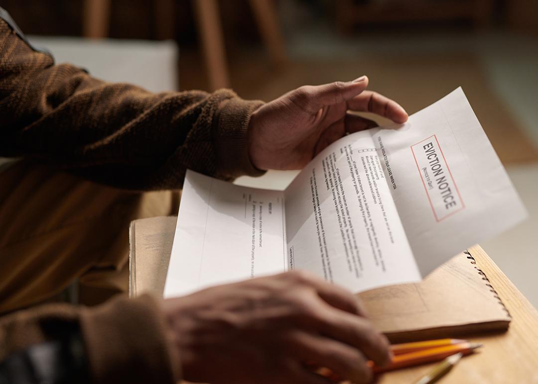 Close-up of a person reading an eviction notice letter.