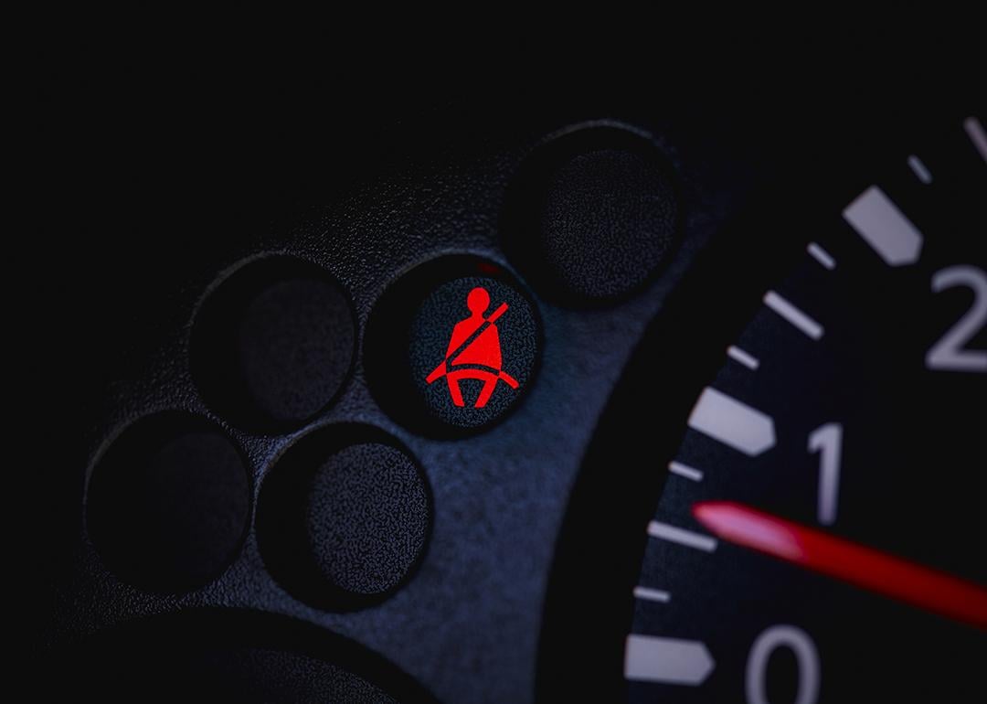 A car's dashboard with the seatbelt warning light turned on.