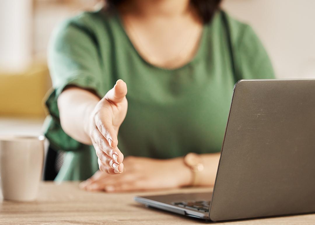 A woman extending her hand for a handshake.