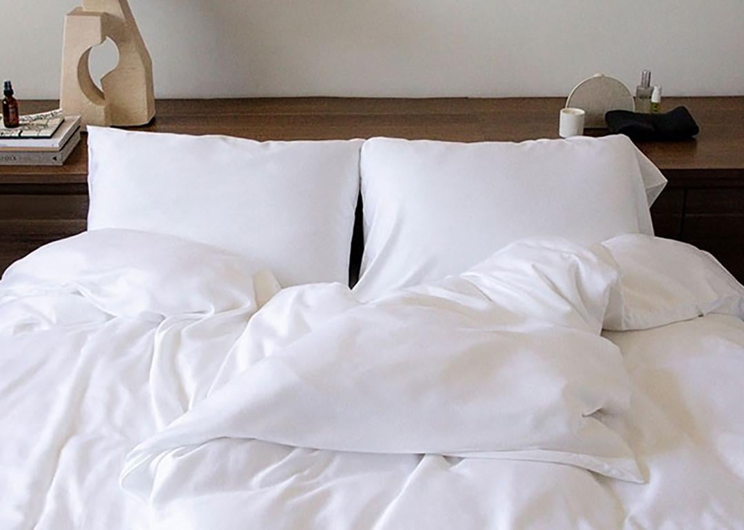 A double size bed with white sheets.